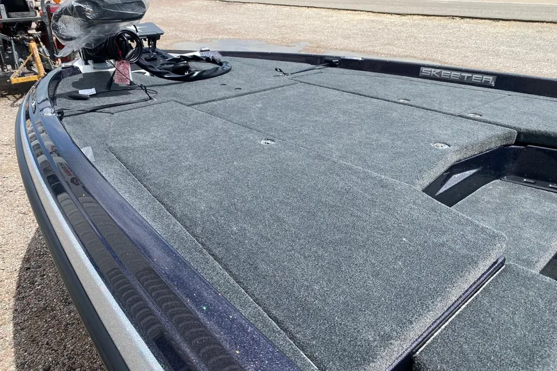 Slide: The Image of 2026 Skeeter ZXE20 boat deck with carpeted surface and equipment. - 10