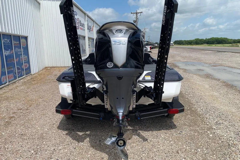 Slide: The Image of 2026 Skeeter ZXE20 boat with powerful outboard motor, parked on gravel near dealership. - 5