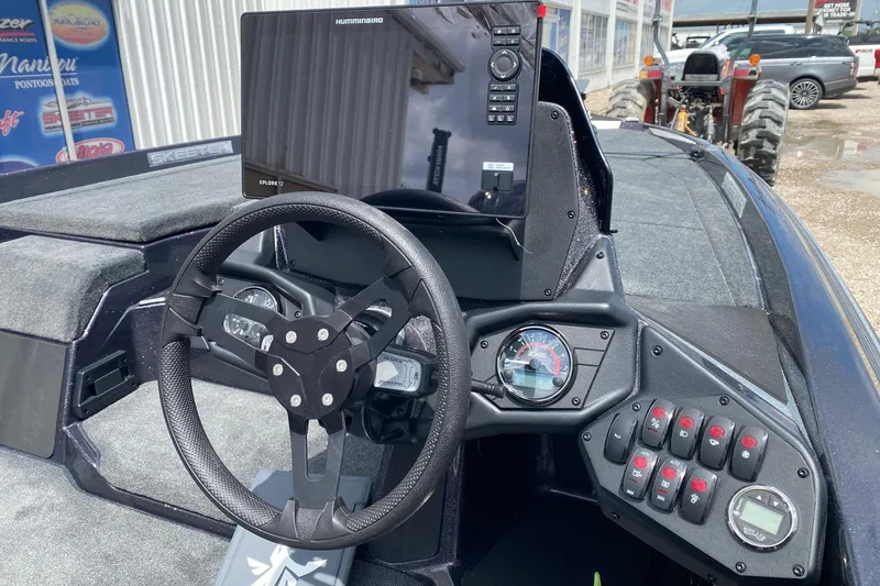 Slide: The Image of 2026 Skeeter ZXE20 boat dashboard with steering wheel and Humminbird Xplore 12 display. - 7