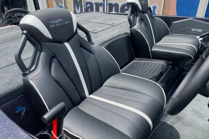 Slide: The Image of 2026 Skeeter ZXE20 boat interior with sleek black and white seating design. - 8