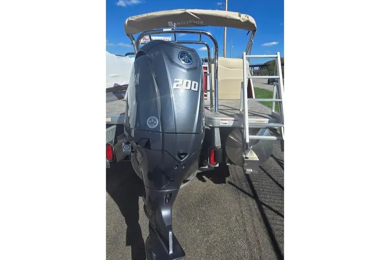 Slide: The Image of 2025 Godfrey Sweetwater 2286 SB pontoon boat with Yamaha 200 engine, rear view. - 2