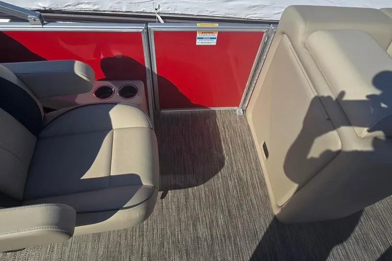 Slide: The Image of Interior of 2025 Godfrey Sweetwater 2286 SB pontoon boat with beige seating and red panel. - 4