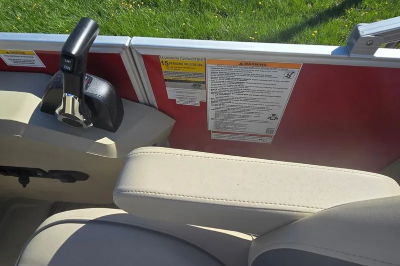 Slide: The Image of Interior of 2025 Godfrey Sweetwater 2286 SB boat, showing control lever and capacity warning. - 6