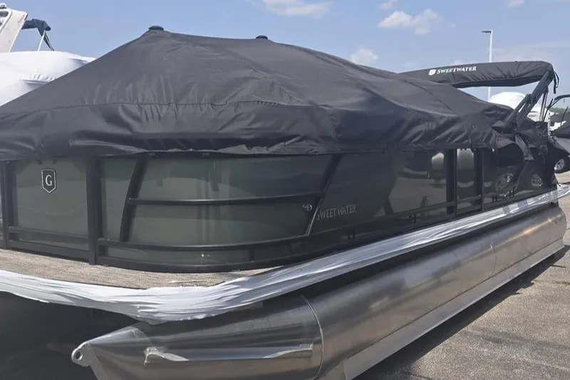 The Image of 2025 Godfrey Sweetwater 2286 MT pontoon boat with black cover on a sunny day. - 1