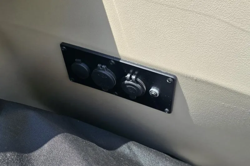 Slide: The Image of Power outlets on 2025 Godfrey Sweetwater 2286 MT boat interior panel. - 3