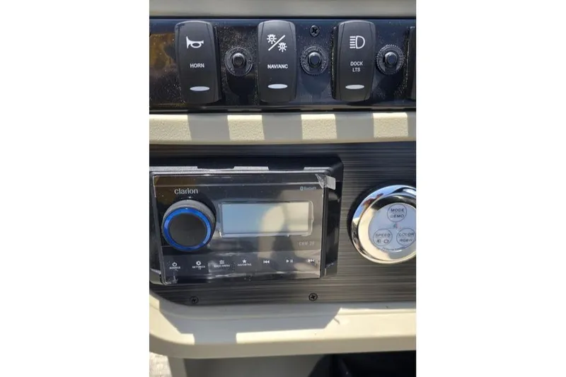Slide: The Image of Control panel of 2025 Godfrey Sweetwater 2286 MT with switches and audio system. - 4