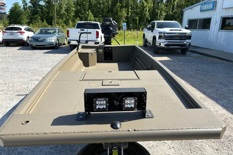 Slide: The Image of 2026 Gator Tail 1748 Gator Series boat in parking lot with trucks and trees. - 6