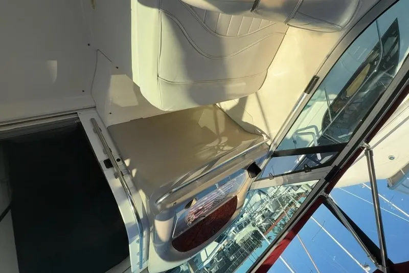 Slide: The Image of Interior view of a 1998 Maxum 3700 SCR boat with seating and glass panels. - 12