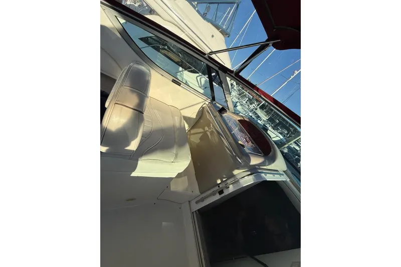 Slide: The Image of 1998 Maxum 3700 SCR boat interior with white seating and dashboard. - 13