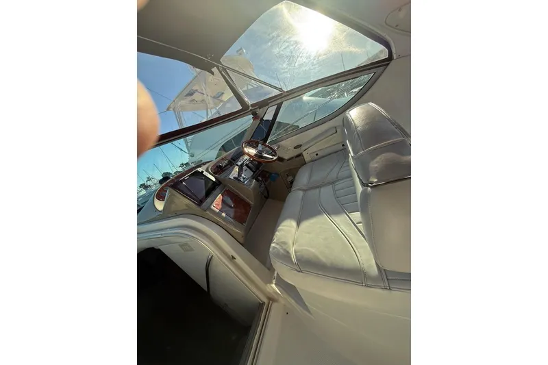 Slide: The Image of Interior view of 1998 Maxum 3700 SCR yacht cockpit with leather seating and steering wheel. - 14