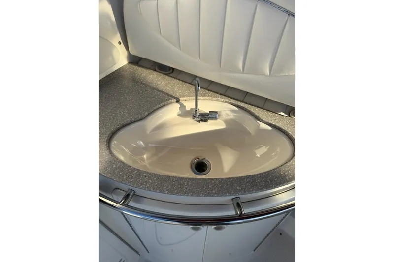 Slide: The Image of 1998 Maxum 3700 SCR boat sink with modern faucet and sleek countertop design. - 17
