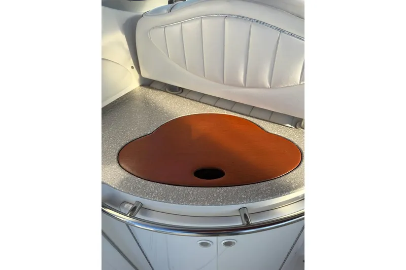 Slide: The Image of 1998 Maxum 3700 SCR boat interior with wooden countertop and white cushioned seating. - 18
