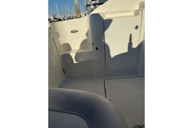 Slide: The Image of 1998 Maxum 3700 SCR boat interior with shadows and marina background. - 20