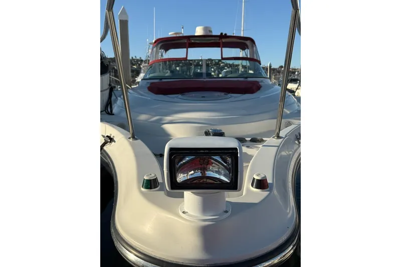 Slide: The Image of 1998 Maxum 3700 SCR yacht with red accents, docked in a marina. - 24