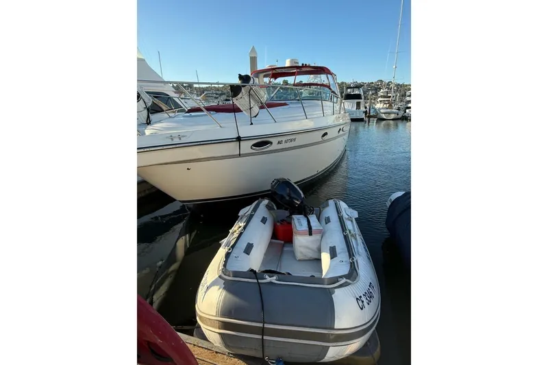 Slide: The Image of 1998 Maxum 3700 SCR yacht docked with inflatable boat in marina. - 25