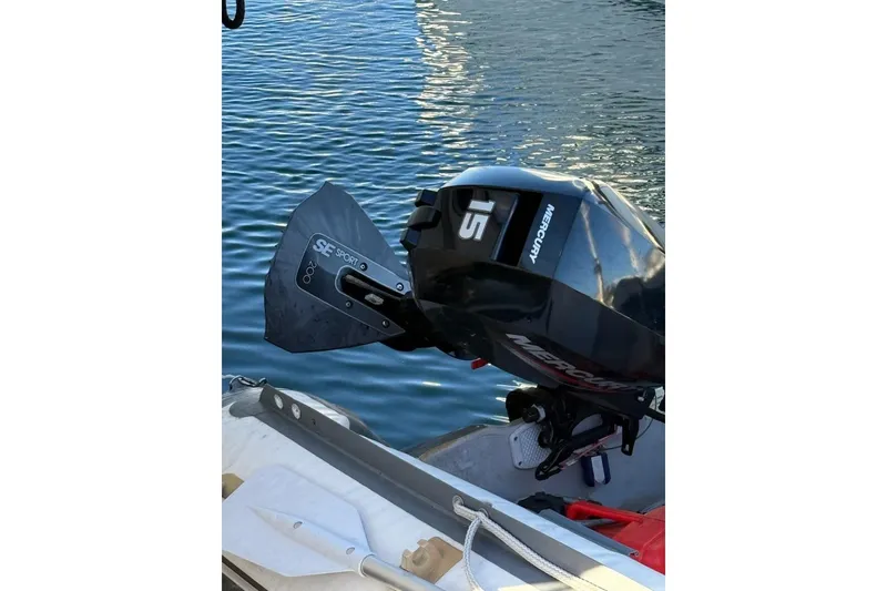 Slide: The Image of Outboard motor on a 1998 Maxum 3700 SCR boat, docked on calm water. - 26