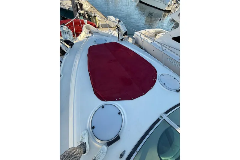 Slide: The Image of 1998 Maxum 3700 SCR yacht deck with red cover, docked at marina. - 32