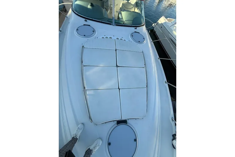 Slide: The Image of 1998 Maxum 3700 SCR yacht deck with cushioned seating, docked by the water. - 34