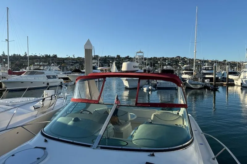 Slide: The Image of 1998 Maxum 3700 SCR yacht docked in a marina, surrounded by other boats. - 37
