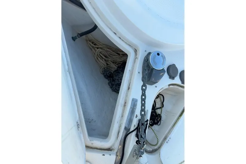 Slide: The Image of Anchor storage compartment on a 1998 Maxum 3700 SCR boat, featuring chain and rope. - 38