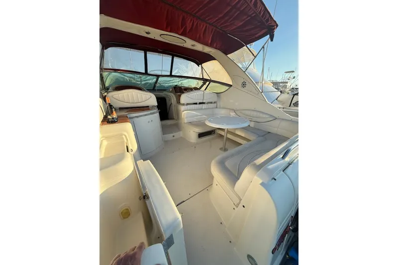 Slide: The Image of 1998 Maxum 3700 SCR yacht interior with seating, table, and canopy. - 39