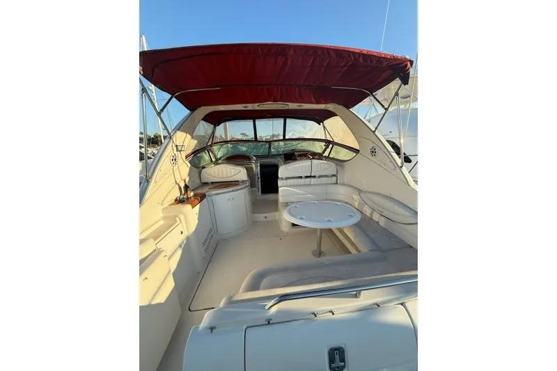 Slide: The Image of 1998 Maxum 3700 SCR yacht interior with red canopy and seating area. - 40