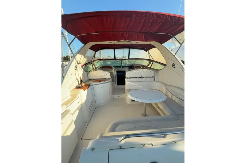 Slide: The Image of 1998 Maxum 3700 SCR yacht interior with red canopy and white seating. - 41