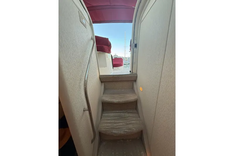 Slide: The Image of Stairway on 1998 Maxum 3700 SCR yacht leading to deck with red canopy. - 45