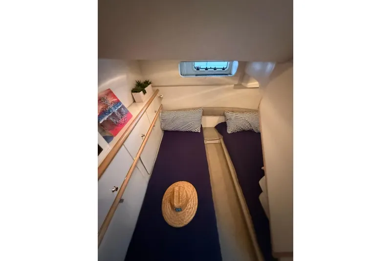 Slide: The Image of Cozy cabin interior of 1998 Maxum 3700 SCR yacht with twin beds and nautical decor. - 47