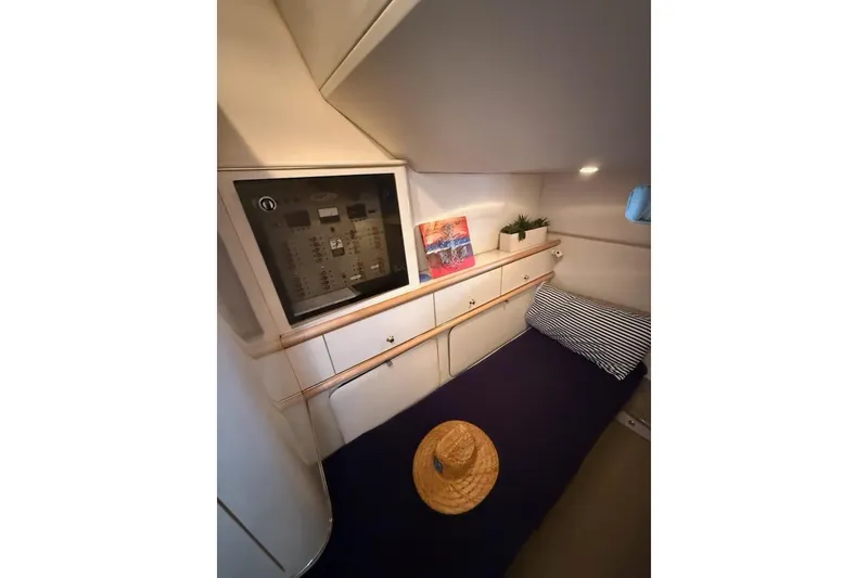 Slide: The Image of Cozy cabin interior of 1998 Maxum 3700 SCR yacht with bed, control panel, and decor. - 48