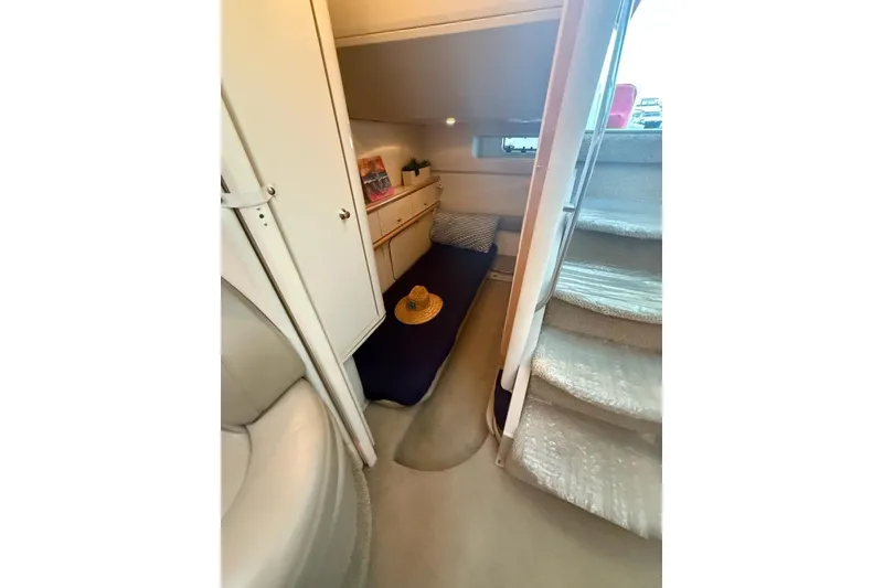 Slide: The Image of 1998 Maxum 3700 SCR cabin interior with cozy bed, stairs, and storage. - 49