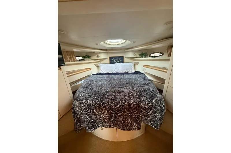 Slide: The Image of Cozy bedroom interior of 1998 Maxum 3700 SCR yacht with patterned bedding. - 50