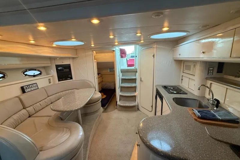 Slide: The Image of Luxurious interior of a 1998 Maxum 3700 SCR yacht with modern amenities and elegant design. - 52