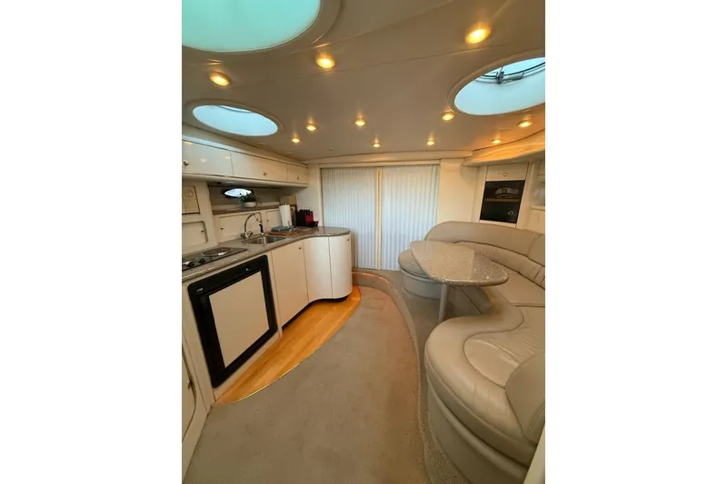 Slide: The Image of Luxurious interior of 1998 Maxum 3700 SCR yacht with modern kitchen and seating area. - 53