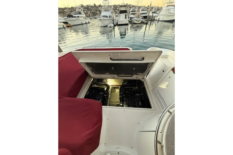 Slide: The Image of 1998 Maxum 3700 SCR yacht engine compartment open at marina, showcasing engine details. - 58