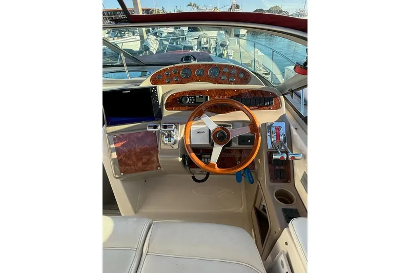 Slide: The Image of 1998 Maxum 3700 SCR boat helm with wooden steering wheel and control panel. - 6