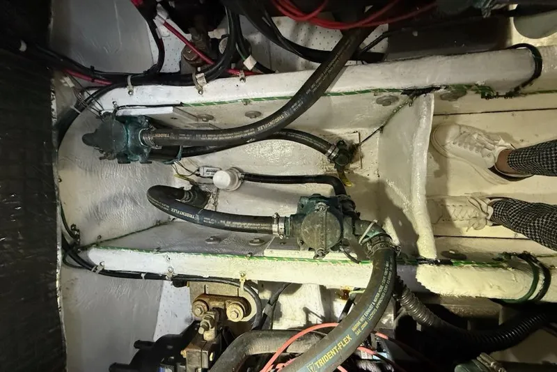 Slide: The Image of Engine compartment of a 1998 Maxum 3700 SCR boat, showing hoses and mechanical components. - 61