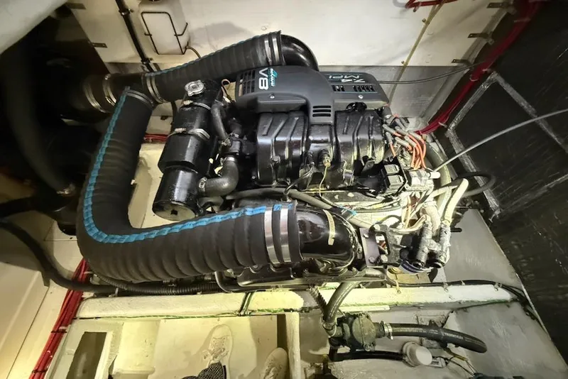 Slide: The Image of Engine compartment of a 1998 Maxum 3700 SCR boat, featuring a V8 engine. - 62