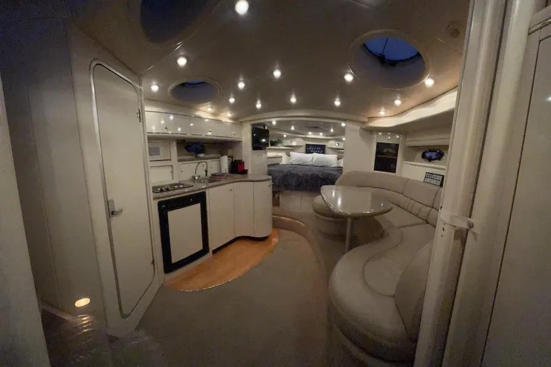 Slide: The Image of Luxurious interior of a 1998 Maxum 3700 SCR yacht with modern amenities and cozy seating. - 65