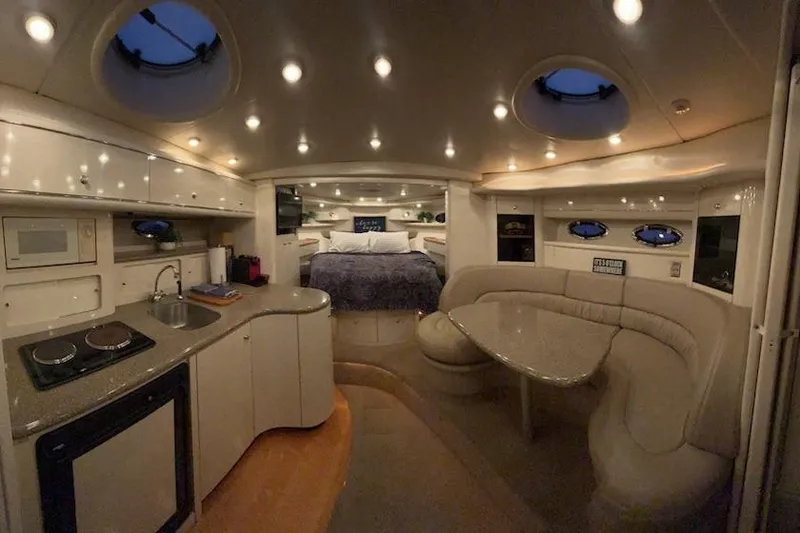 Slide: The Image of Luxurious interior of a 1998 Maxum 3700 SCR yacht with modern amenities and cozy seating. - 66