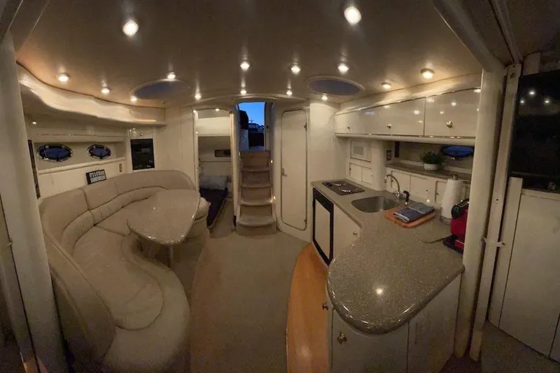 Slide: The Image of Luxurious interior of a 1998 Maxum 3700 SCR yacht with modern kitchen and seating area. - 67