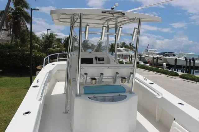 Slide: The Image of 2017 Twin Vee OceanCat 260 TE boat docked with palm trees in background. - 13