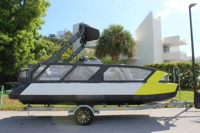 Slide: The Image of 2023 Sea-Doo Switch Cruise 21 on trailer, modern architecture in background. - 4