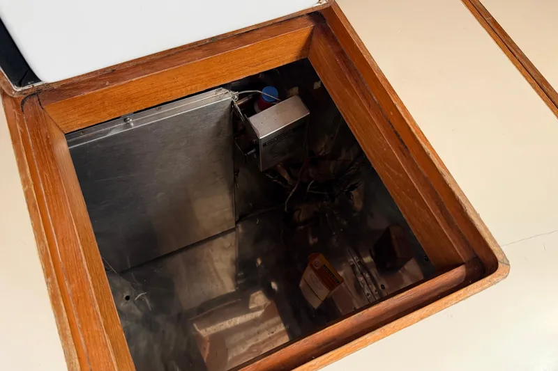 Slide: The Image of Open compartment in 1983 Tanton 44 boat, showcasing interior storage space. - 19