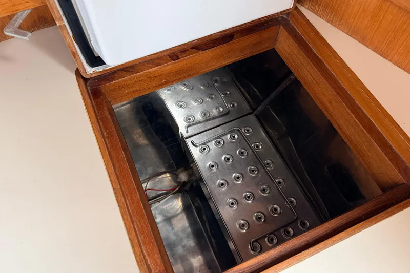 Slide: The Image of Wooden compartment with metal panel inside a 1983 Tanton 44 model. - 20