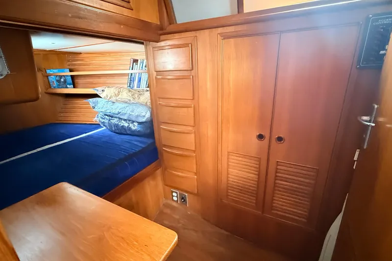 Slide: The Image of Cozy wooden cabin interior of 1983 Tanton 44 sailboat with bed and shelves. - 21