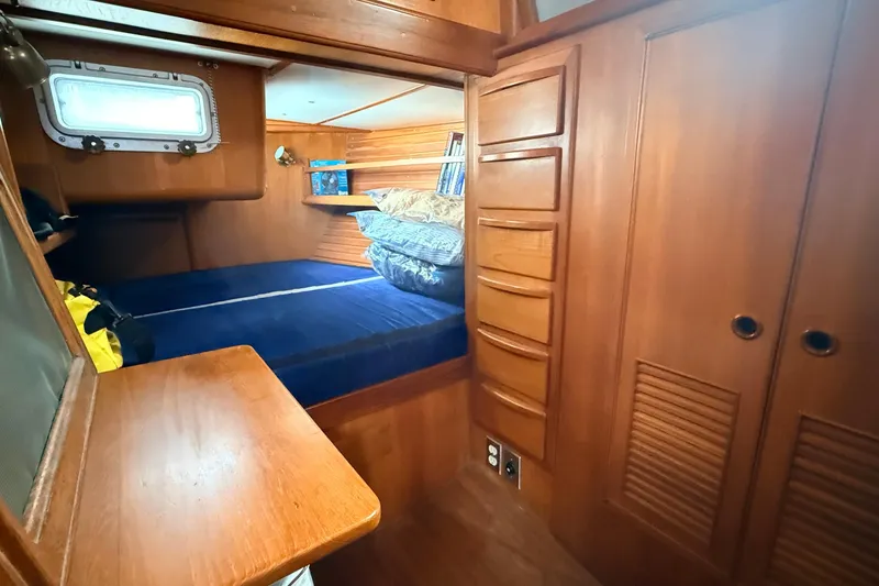 Slide: The Image of Cozy wooden cabin interior of 1983 Tanton 44 sailboat with bed and storage. - 22