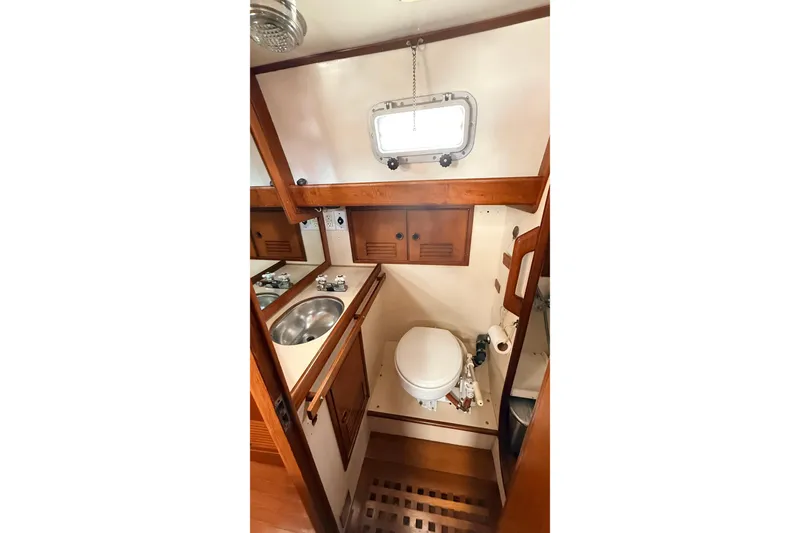 Slide: The Image of Compact 1983 Tanton 44 yacht bathroom with wooden accents and stainless steel sink. - 24