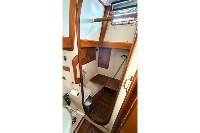 Slide: The Image of 1983 Tanton 44 yacht bathroom with wooden accents and compact design. - 25