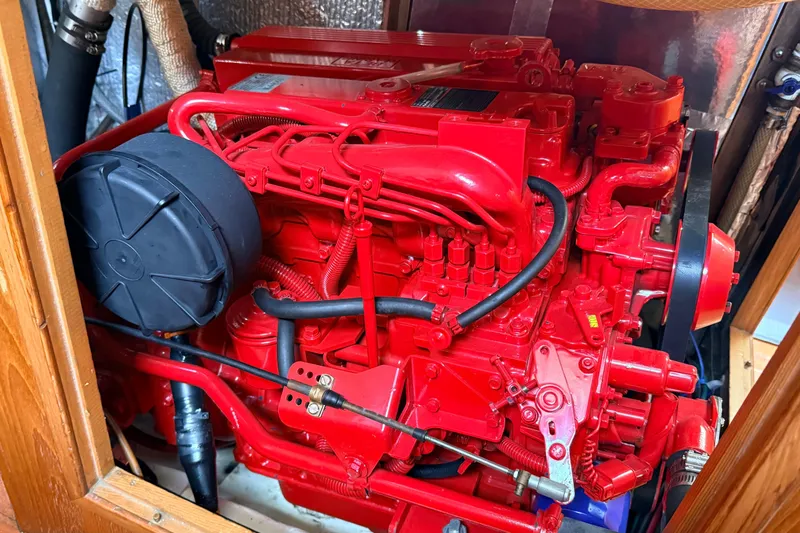 Slide: The Image of Red Tanton 44 engine from 1983, detailed view with hoses and components. - 29